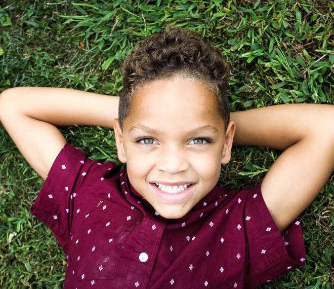 boy laying in grass